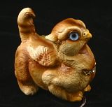 Tan crouching griffin chick